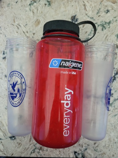 2 shrunken water bottles that previously held 1L next to my old trusty 1L Nalgene