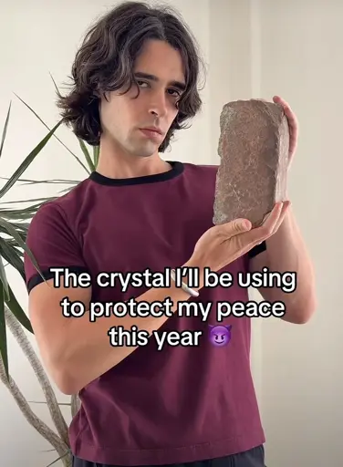 A phot of a person holding a brick with the caption “ The crystal I’ll be using to protect my peace this year”
