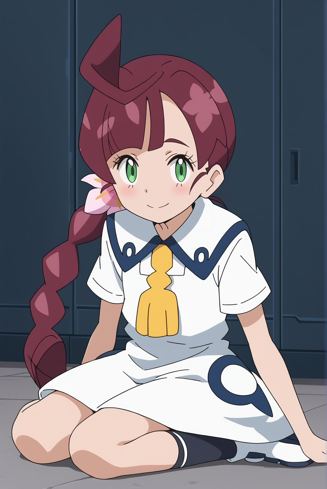 A girl with green eyes, and long maroon hair styled in a braid with a pink flower. She wears a white sailor dress with a yellow ribbon around her neck, and dark blue accents. She is sitting on a gray floor in front of dark blue lockers, giving a friendly, shy smile. 