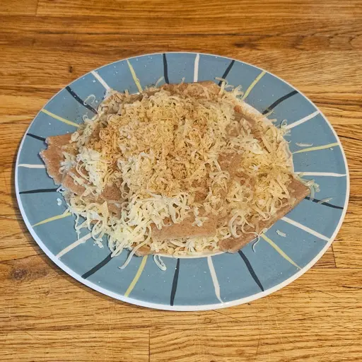 A plate of dry whole wheat pasta flates with cheese and poudre douce in between