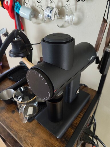 The Timemore 078S grinder sitting on a coffee bar with the replacement hopper installed.